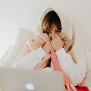 Woman Wrapped in a Blanket with a Laptop